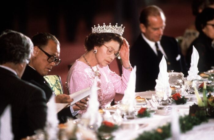 This image has an empty alt attribute; its file name is the-queen-adjusting-her-tiara-whilst-reading-the-menu-news-photo-1575560226-700x460.jpg