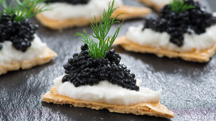This image has an empty alt attribute; its file name is caviar-crackers-700x394.jpg
